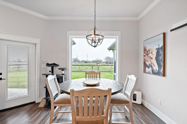 12078 County Road 175, Iola, TX 77861 - dining space featuring a chandelier, dark wood finished floors, crown molding, and baseboards