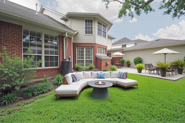 1902 Rosebay Ct, Sugar Land, TX 77479 - back of property with brick siding, a lawn, a patio area, and an outdoor living space with a fire pit