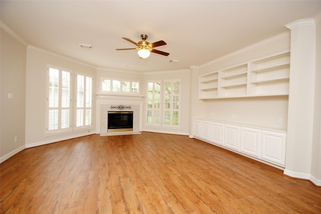 1902 Rosebay Ct, Sugar Land, TX 77479 - unfurnished living room with light wood finished floors, ceiling fan, a fireplace, crown molding, and baseboards