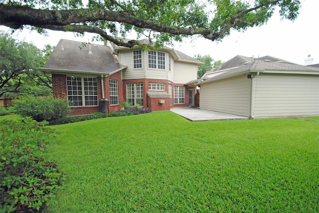 1902 Rosebay Ct, Sugar Land, TX 77479 - back of house featuring brick siding, a patio, and a yard