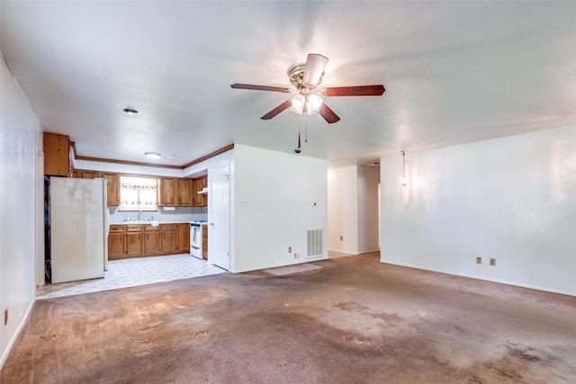 119 Delaware Dr, Conroe, TX 77316 - unfurnished living room featuring ceiling fan, baseboards, a sink, and light carpet