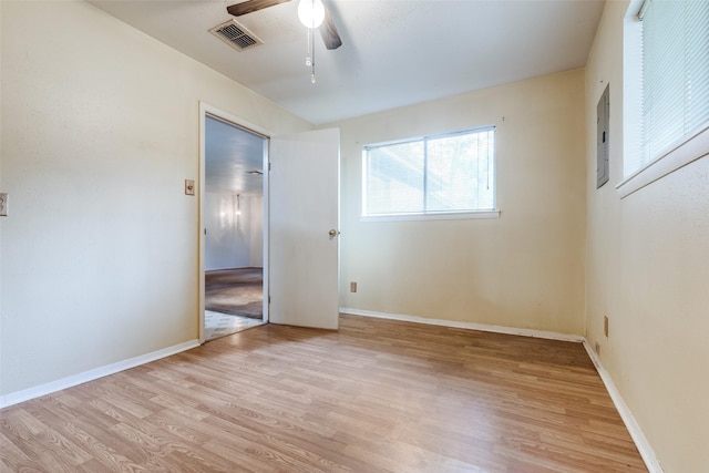 119 Delaware Dr, Conroe, TX 77316 - unfurnished bedroom with light wood-style floors, a ceiling fan, baseboards, and electric panel