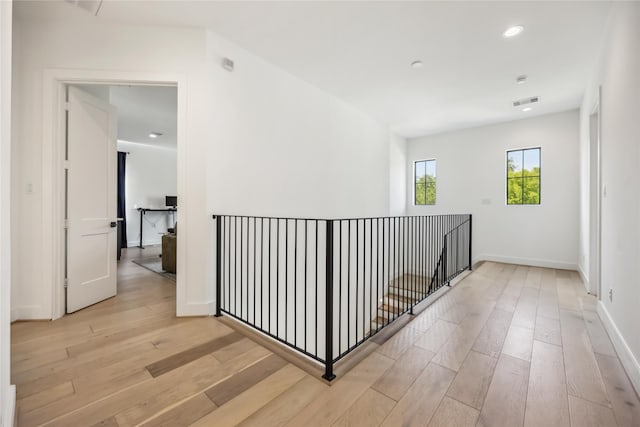 1913 Ebony Ln, Houston, TX 77018 - hallway with light wood-style flooring, recessed lighting, baseboards, and an upstairs landing