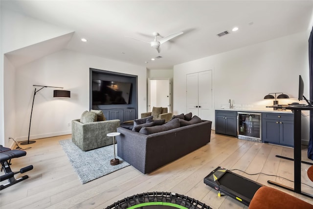 1913 Ebony Ln, Houston, TX 77018 - living room featuring wine cooler, wet bar, light wood-style flooring, a ceiling fan, and recessed lighting