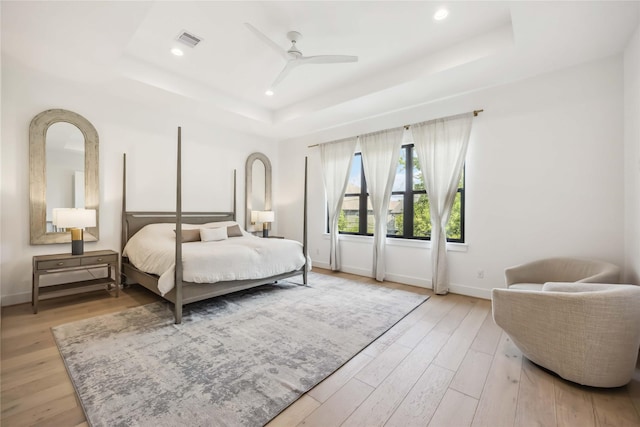 1913 Ebony Ln, Houston, TX 77018 - bedroom featuring a tray ceiling, baseboards, light wood-type flooring, and recessed lighting