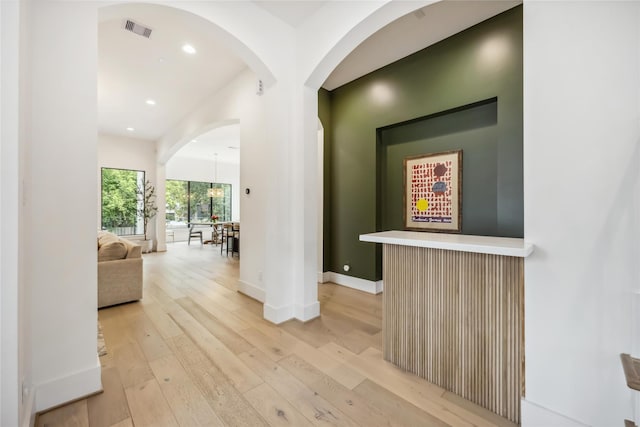 1913 Ebony Ln, Houston, TX 77018 - corridor featuring light wood-style flooring, baseboards, recessed lighting, and arched walkways