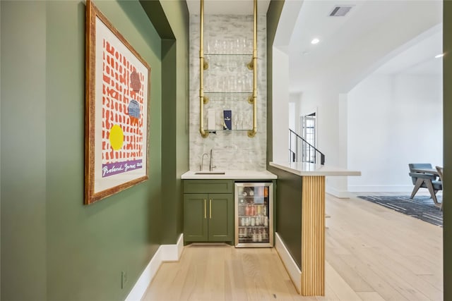 1913 Ebony Ln, Houston, TX 77018 - indoor wet bar featuring beverage cooler, light wood-style flooring, baseboards, and recessed lighting