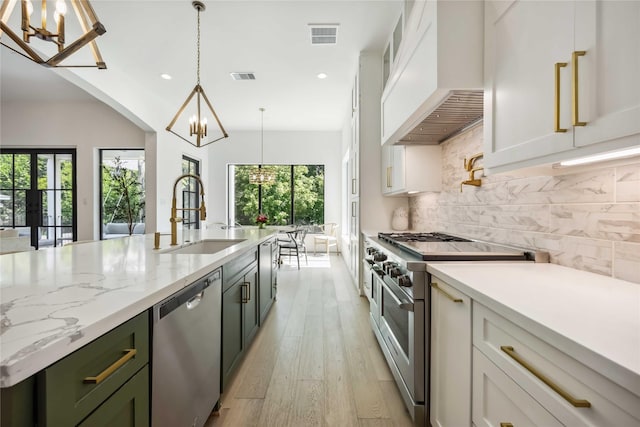 1913 Ebony Ln, Houston, TX 77018 - kitchen with appliances with stainless steel finishes, a chandelier, premium range hood, a sink, and recessed lighting