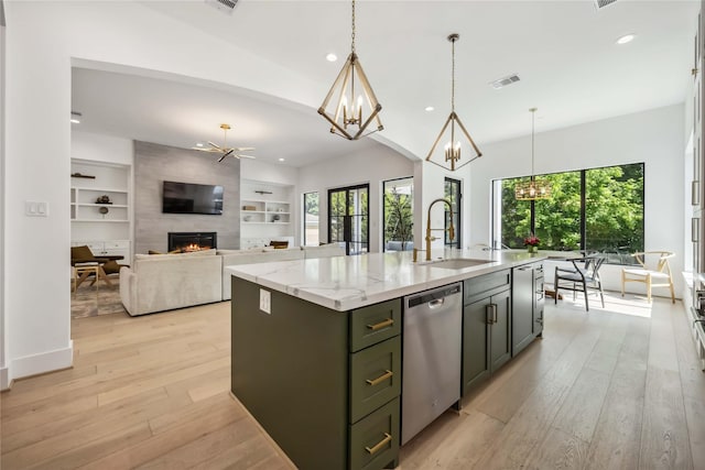1913 Ebony Ln, Houston, TX 77018 - kitchen with dishwasher, a sink, a fireplace, a chandelier, and light wood-type flooring