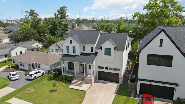 1913 Ebony Ln, Houston, TX 77018 - modern farmhouse featuring an attached garage, a residential view, a standing seam roof, driveway, and covered porch