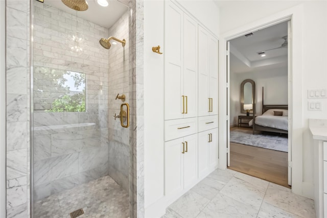 1913 Ebony Ln, Houston, TX 77018 - full bath featuring a stall shower, connected bathroom, marble look tiles, and a tray ceiling