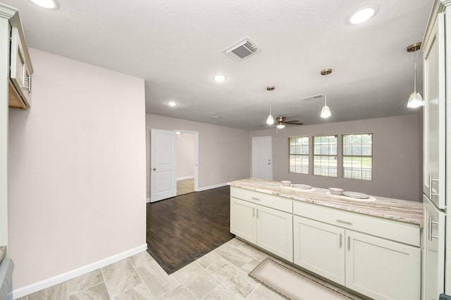 4918 Perry St, Houston, TX 77021 - kitchen with a peninsula, baseboards, recessed lighting, decorative light fixtures, and a ceiling fan
