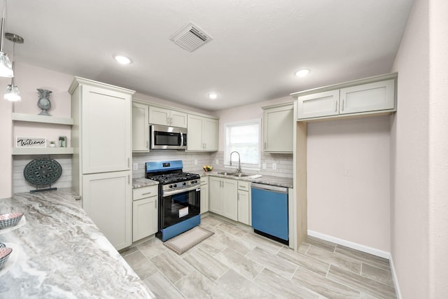 4918 Perry St, Houston, TX 77021 - kitchen featuring appliances with stainless steel finishes, open shelves, tasteful backsplash, a sink, and light stone countertops
