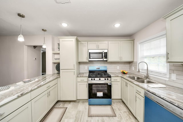 4918 Perry St, Houston, TX 77021 - kitchen featuring stainless steel appliances, a sink, open shelves, decorative backsplash, and pendant lighting