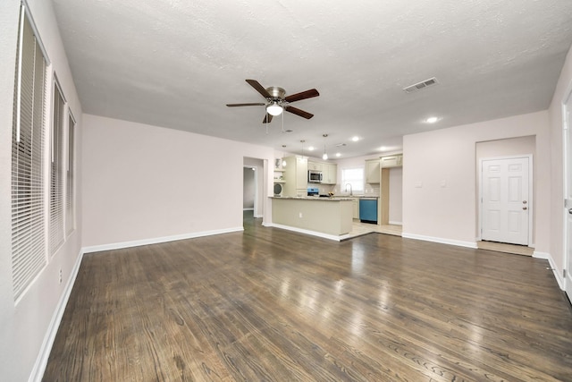 4918 Perry St, Houston, TX 77021 - unfurnished living room with ceiling fan, dark wood-style flooring, recessed lighting, baseboards, and a sink