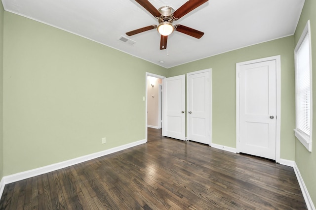 4918 Perry St, Houston, TX 77021 - unfurnished bedroom with baseboards, dark wood-style floors, and ceiling fan