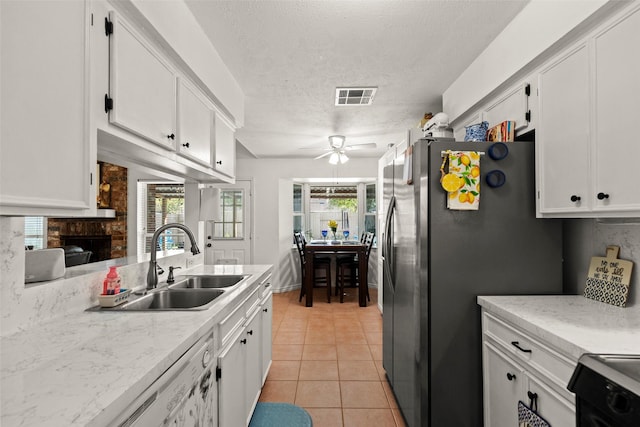 13755 Shirebrook Dr N, Sugar Land, TX 77498 - kitchen featuring a sink, range, white cabinetry, ceiling fan, and light countertops