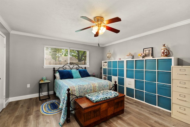 13755 Shirebrook Dr N, Sugar Land, TX 77498 - bedroom with wood finished floors, crown molding, baseboards, and a ceiling fan