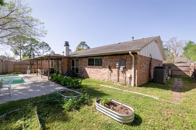 13755 Shirebrook Dr N, Sugar Land, TX 77498 - rear view of house featuring central air condition unit, a patio, brick siding, and roof with shingles
