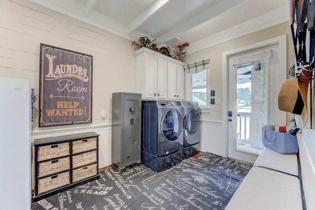 321 Marina Dr, Coldspring, TX 77331 - laundry area with cabinet space, washing machine and dryer, and wood walls