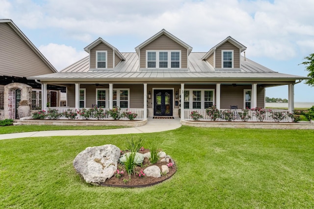 321 Marina Dr, Coldspring, TX 77331 - country-style home featuring covered porch, a standing seam roof, a front lawn, and metal roof