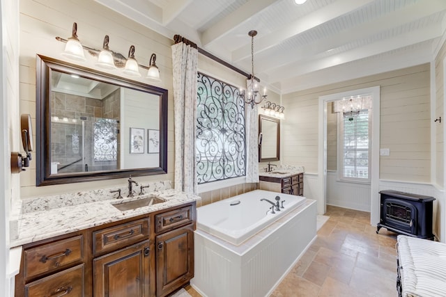321 Marina Dr, Coldspring, TX 77331 - full bathroom with a wood stove, beam ceiling, a chandelier, stone tile flooring, and a garden tub