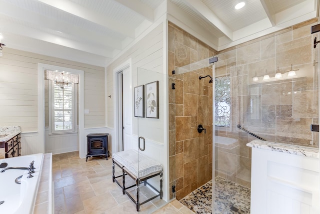 321 Marina Dr, Coldspring, TX 77331 - full bathroom featuring a wood stove, a tile shower, beam ceiling, a bath, and a chandelier