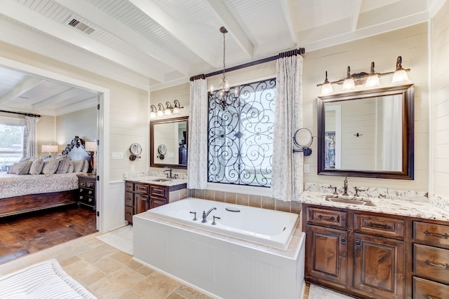 321 Marina Dr, Coldspring, TX 77331 - ensuite bathroom featuring beam ceiling, a garden tub, two vanities, a chandelier, and stone finish flooring