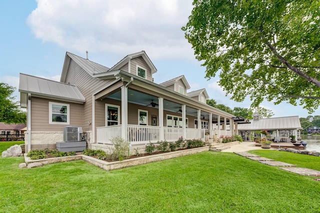 321 Marina Dr, Coldspring, TX 77331 - view of front of property with covered porch, a ceiling fan, a front yard, metal roof, and cooling unit
