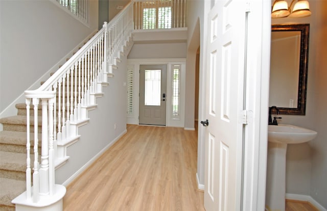 16611 Hope Farm Ln, Cypress, TX 77429 - foyer entrance with light wood-type flooring, stairway, a towering ceiling, and baseboards