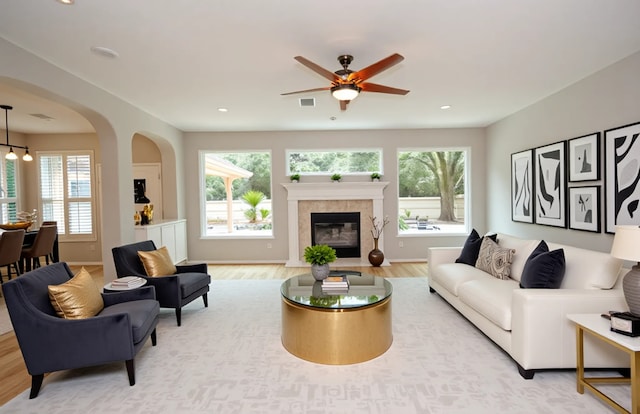 16611 Hope Farm Ln, Cypress, TX 77429 - living room featuring healthy amount of natural light, ceiling fan, light wood-style floors, a tiled fireplace, and recessed lighting