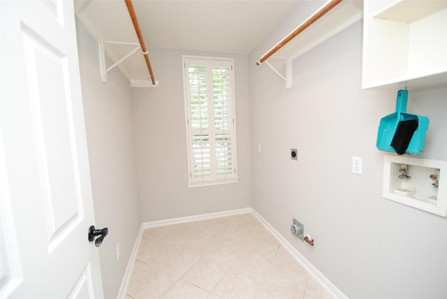 16611 Hope Farm Ln, Cypress, TX 77429 - laundry area with washer hookup, electric dryer hookup, gas dryer hookup, light tile patterned floors, and baseboards