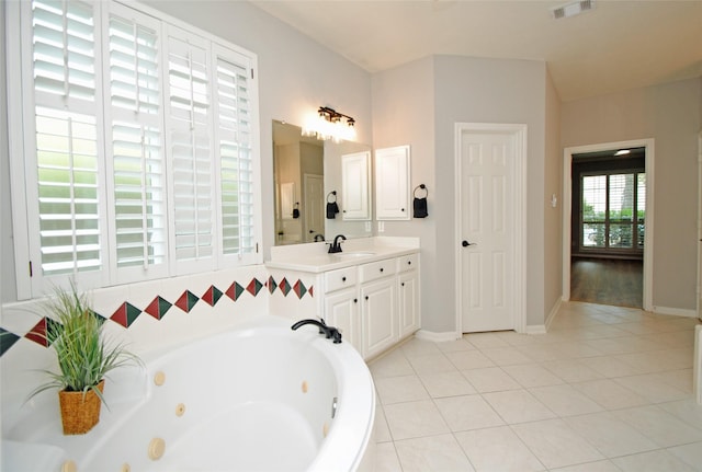 16611 Hope Farm Ln, Cypress, TX 77429 - bathroom featuring a tub with jets, vanity, tile patterned floors, and baseboards