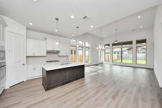 21111 Flowerhorn Dr, Cypress, TX 77433 - kitchen featuring a sink, light countertops, open floor plan, recessed lighting, and black stovetop
