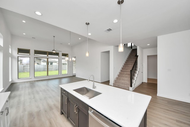 21111 Flowerhorn Dr, Cypress, TX 77433 - kitchen with open floor plan, a sink, stainless steel dishwasher, light countertops, and light wood-style flooring