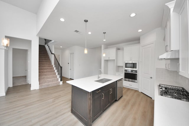 21111 Flowerhorn Dr, Cypress, TX 77433 - kitchen featuring a sink, appliances with stainless steel finishes, under cabinet range hood, recessed lighting, and white cabinets