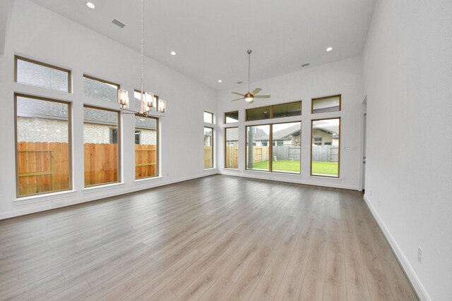 21111 Flowerhorn Dr, Cypress, TX 77433 - unfurnished room with ceiling fan, light wood-style flooring, a chandelier, baseboards, and recessed lighting
