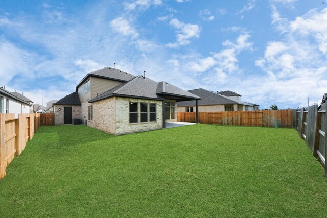 21111 Flowerhorn Dr, Cypress, TX 77433 - rear view of house with a shingled roof, brick siding, and a patio