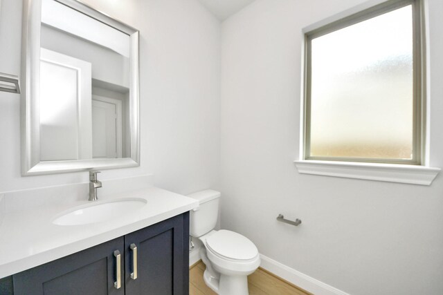 21114 Flowerhorn Dr, Cypress, TX 77433 - half bath featuring toilet, baseboards, vanity, and wood finished floors