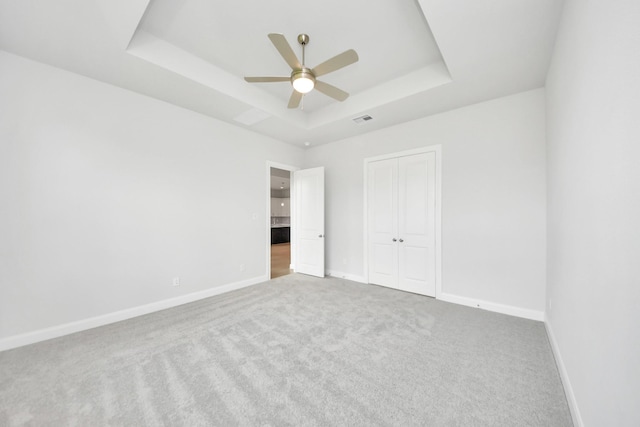 21114 Flowerhorn Dr, Cypress, TX 77433 - unfurnished bedroom with a tray ceiling, carpet, and baseboards