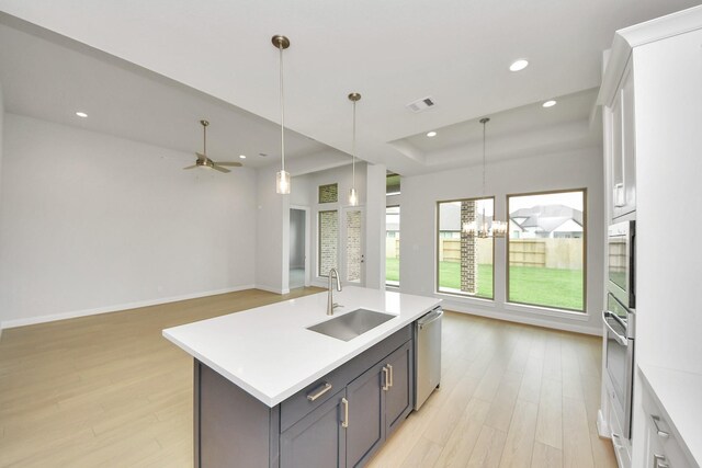 21114 Flowerhorn Dr, Cypress, TX 77433 - kitchen with a sink, stainless steel dishwasher, light wood-type flooring, recessed lighting, and light countertops