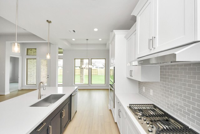 21114 Flowerhorn Dr, Cypress, TX 77433 - kitchen with a sink, appliances with stainless steel finishes, white cabinetry, light countertops, and recessed lighting