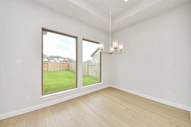 21114 Flowerhorn Dr, Cypress, TX 77433 - unfurnished room with a chandelier, baseboards, wood finished floors, and plenty of natural light