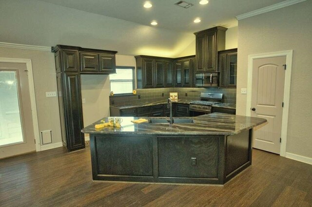 107 Brazos Ct, Richwood, TX 77531 - kitchen featuring stainless steel appliances, a sink, dark wood finished floors, tasteful backsplash, and dark stone countertops