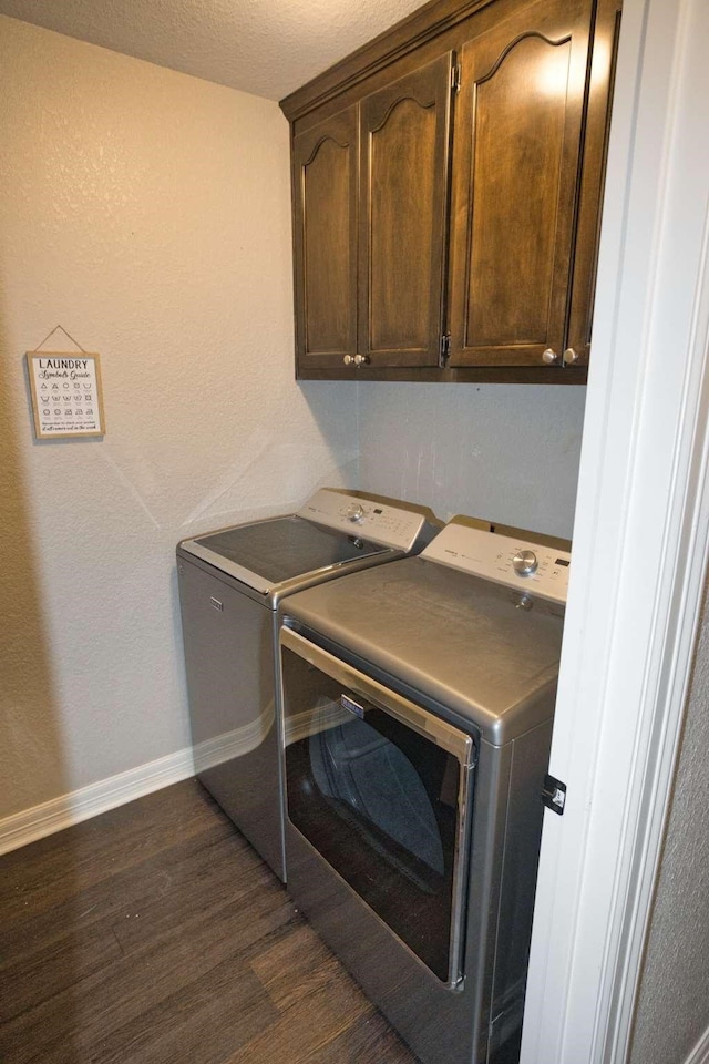 107 Brazos Ct, Richwood, TX 77531 - laundry room featuring washer and dryer, dark wood finished floors, cabinet space, and baseboards
