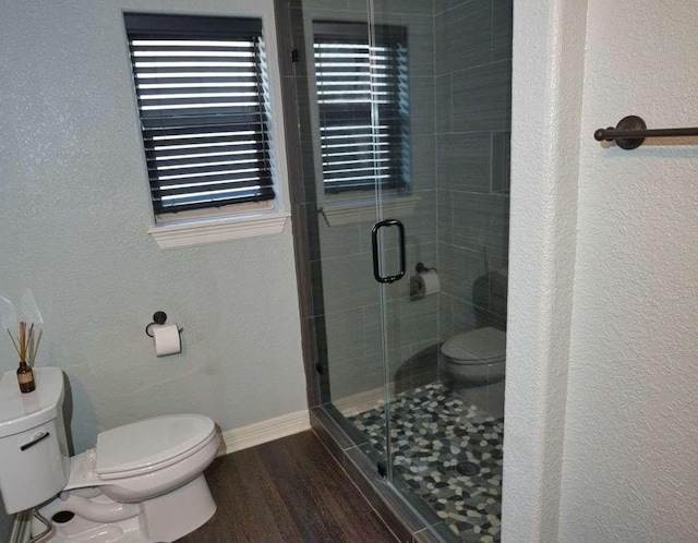 107 Brazos Ct, Richwood, TX 77531 - full bathroom featuring toilet, baseboards, a stall shower, a textured wall, and wood finished floors