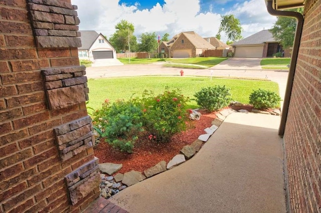 107 Brazos Ct, Richwood, TX 77531 - view of green lawn featuring a detached garage and a residential view