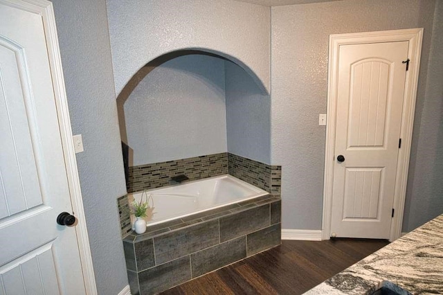 107 Brazos Ct, Richwood, TX 77531 - full bathroom featuring a garden tub, wood finished floors, and baseboards