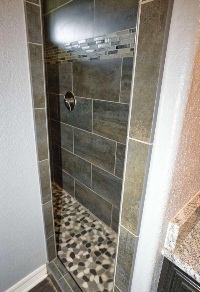 107 Brazos Ct, Richwood, TX 77531 - full bathroom with tiled shower and a textured wall