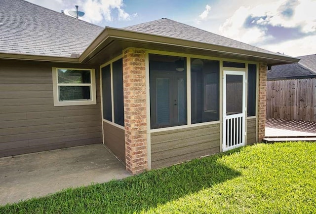 107 Brazos Ct, Richwood, TX 77531 - view of home's exterior with a sunroom and a shingled roof